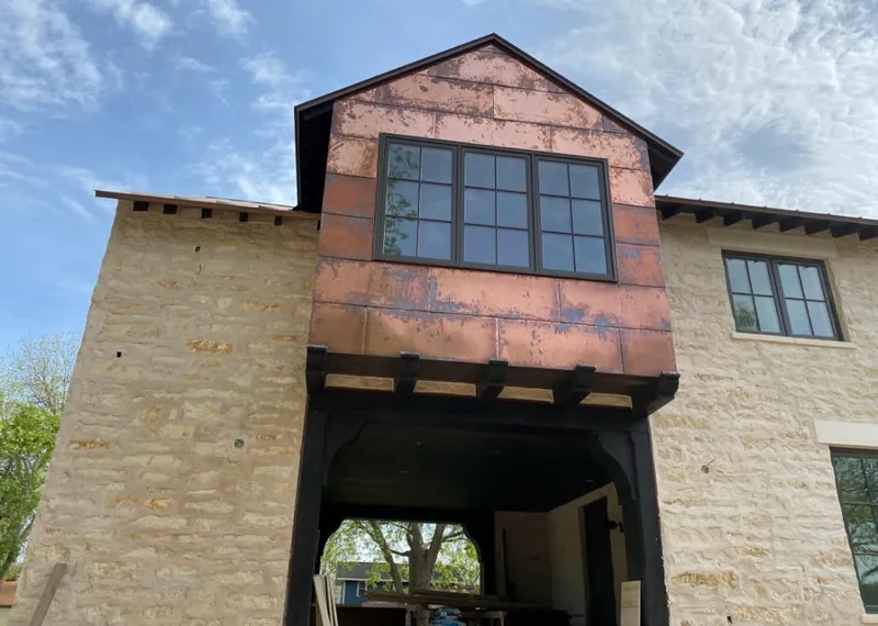 Copper metal panel facade on a stone building for Skylight Installation in Arkansas City