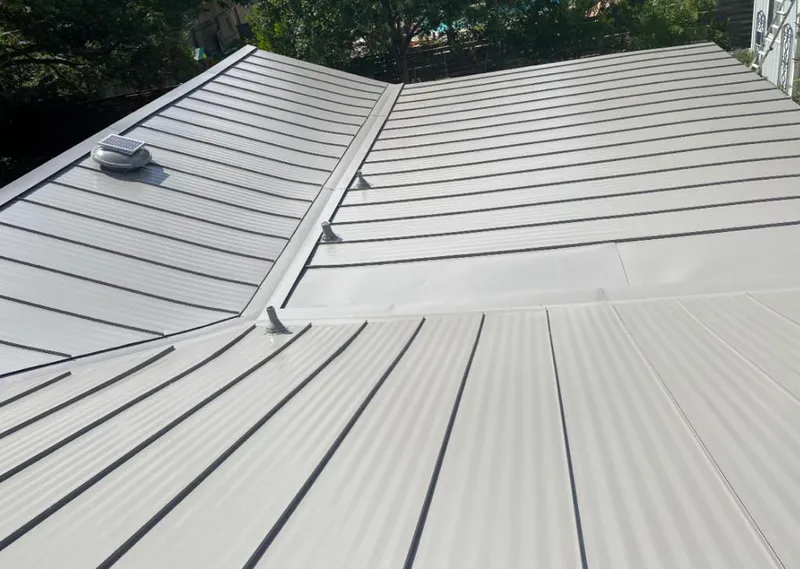 Solar attic fan installed on a metal roof for Roof Ventilation in Arkansas City